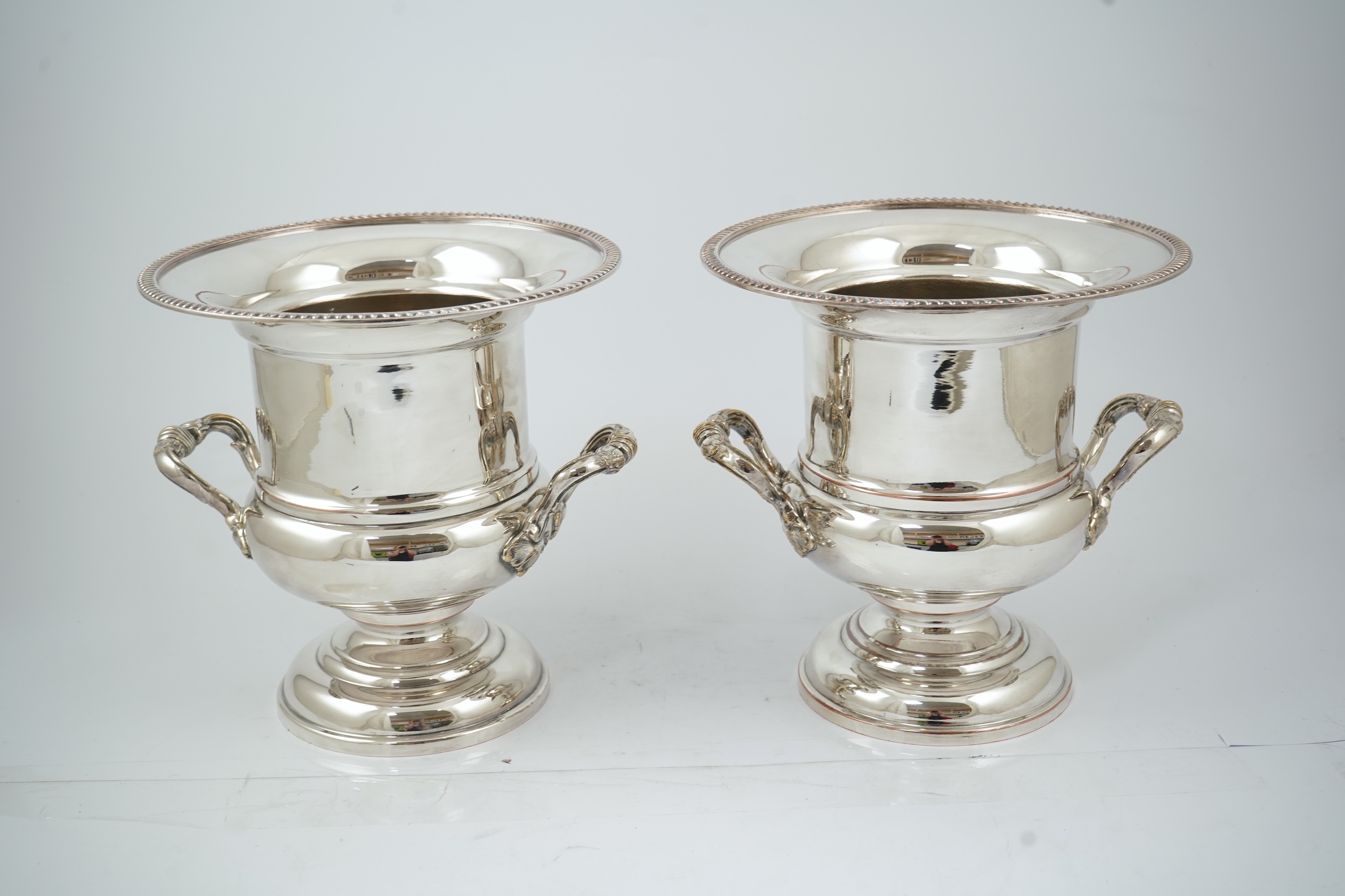 A pair of late 19th/early 20th century silver plated two handled campana shaped wine coolers, makers, FH